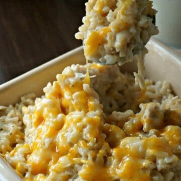 Creamy and Cheesy Chicken and Rice in yellow casserole dish