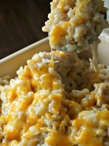 Creamy and Cheesy Chicken and Rice in yellow casserole dish