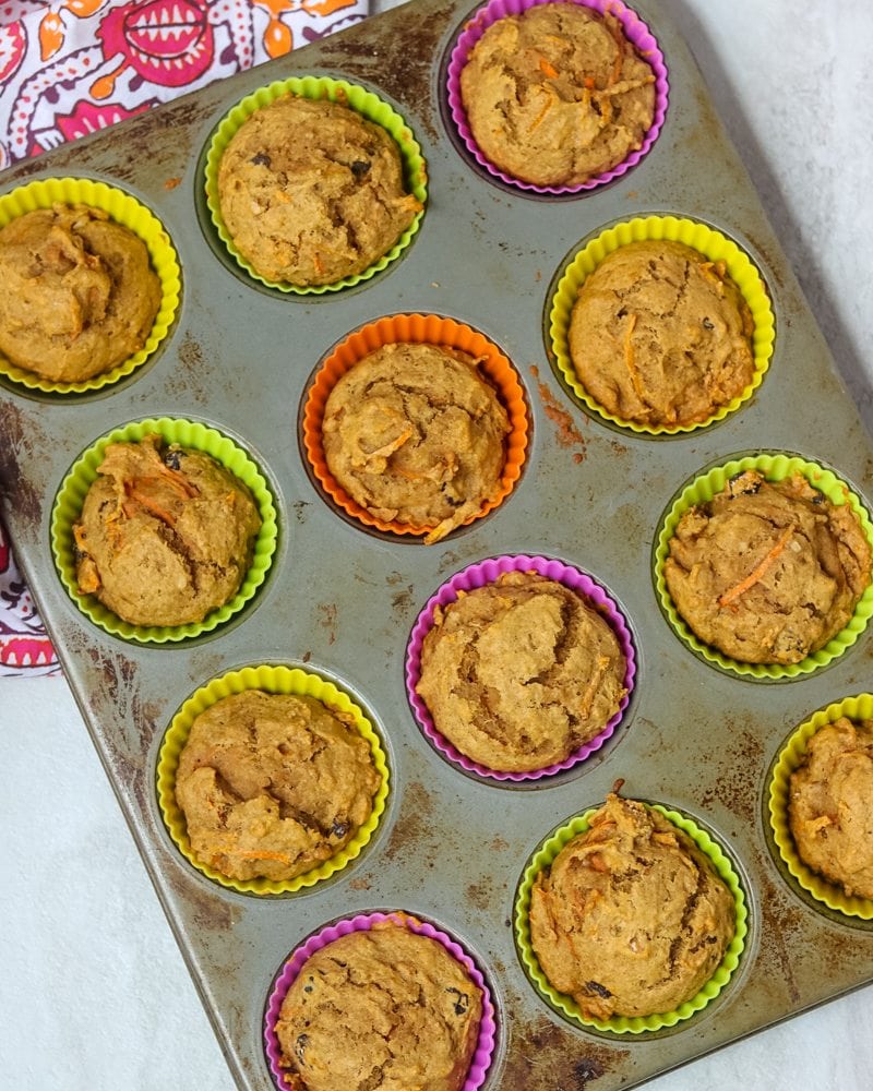 12 carrot cake muffins in silicone muffin liners in 12 cup muffin tin. 