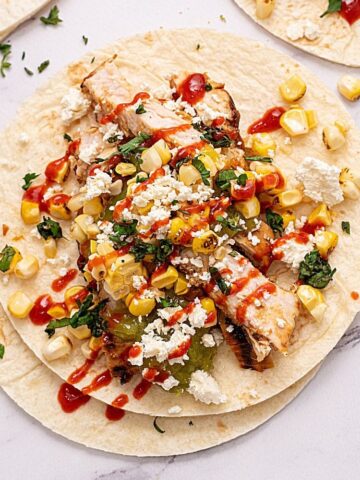 Grilled Chicken Fajita topped with corn salsa and hot sauce