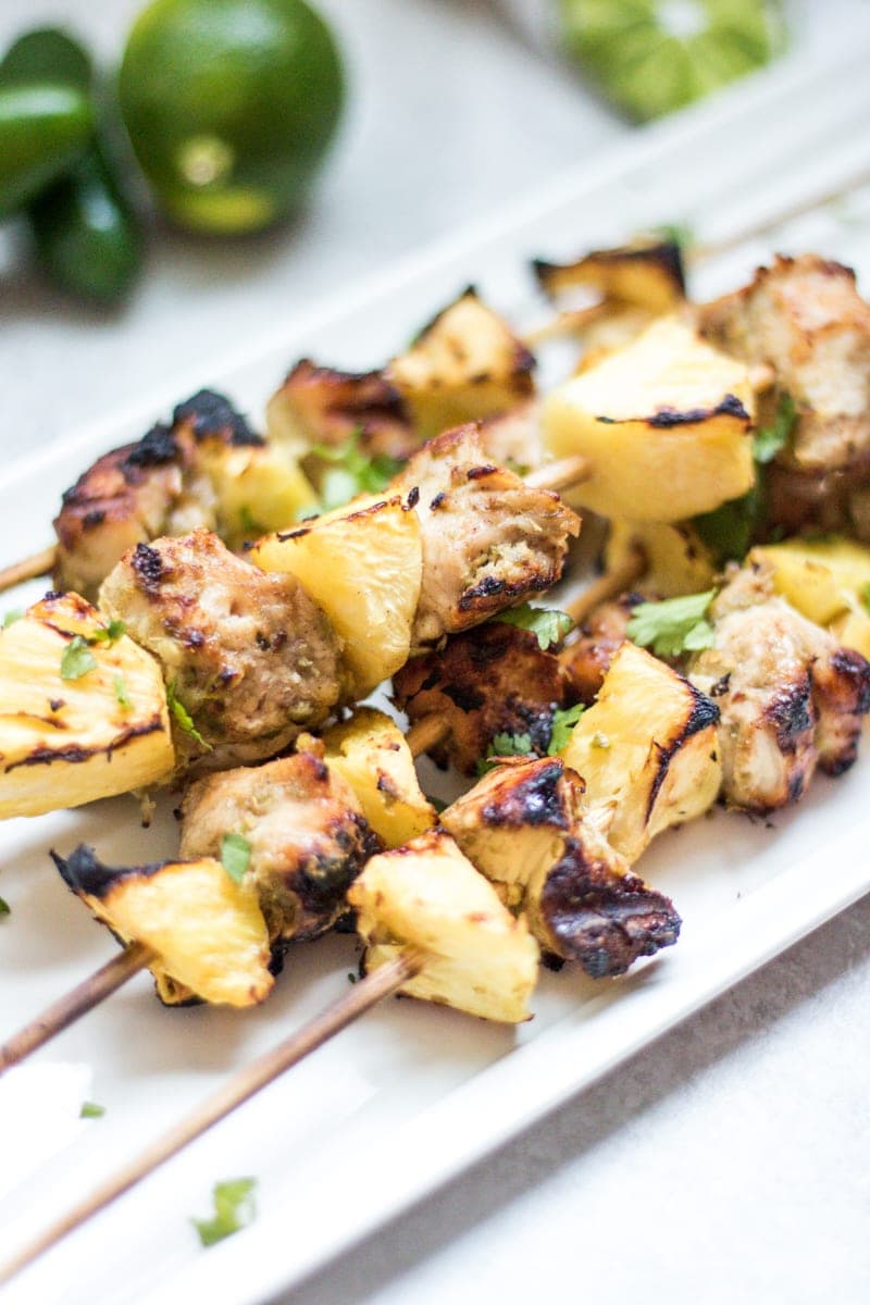 Grilled Chicken Kabobs with Pineapple on white platter.