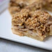 Close of of Apple Pie Bar with shortbread cookie crust and apple filling and oat crumble
