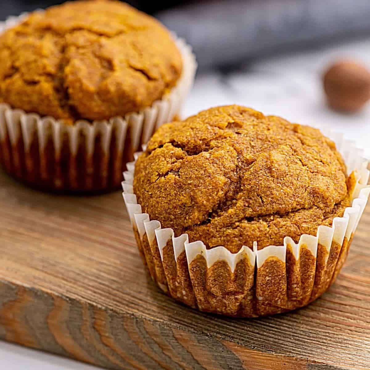 Baked Whole Wheat Pumpkin Muffins on wooden cutting board