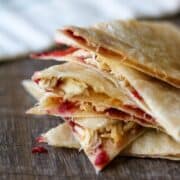 Sliced up turkey quesadilla with cranberry sauce