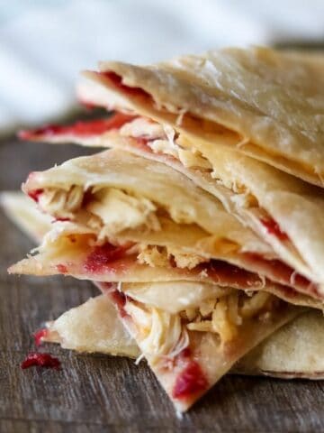 Sliced up turkey quesadilla with cranberry sauce