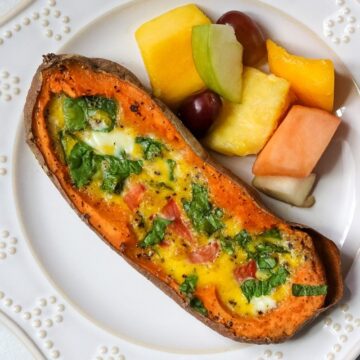 Baked Spinach Omelet in Baked Sweet Potato next to mixed Fruit