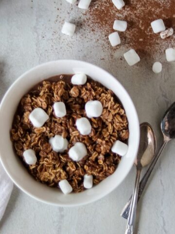 Homemade Hot Cocoa Oatmeal in white bowl topped with marshmallows