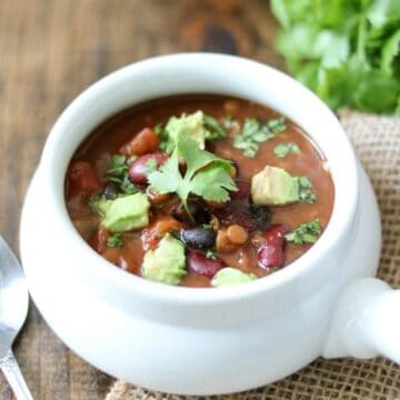 Bowl of Lentil Chili topped with avocado and cilantro