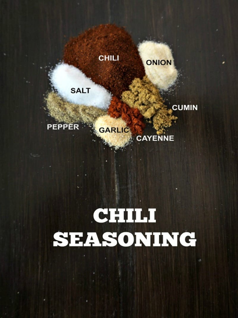 Seasonings for Homemade Chili Seasoning on wooden board with text.