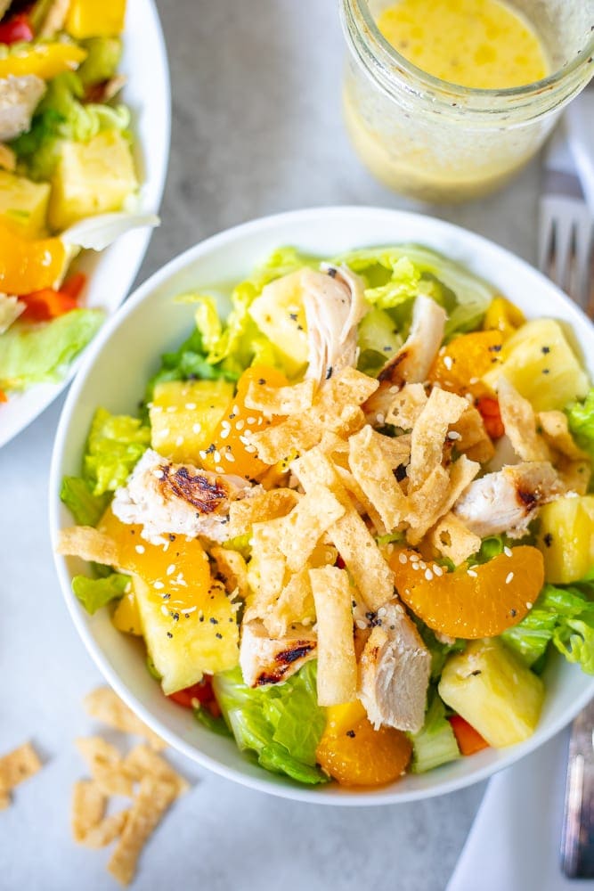 Salad with grilled chicken, tortilla chips, and fresh pineapple