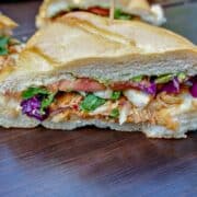 Mexican Chicken Sandwich cut open on wooden cutting board