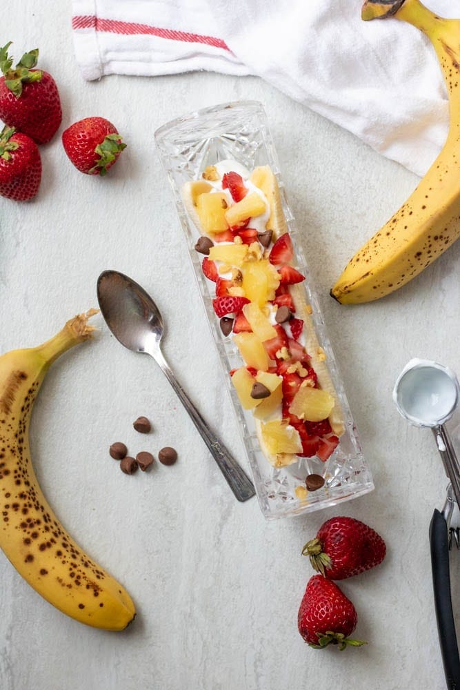 Banana topped with Greek yogurt, fresh pineapple, strawberries and chocolate chips.