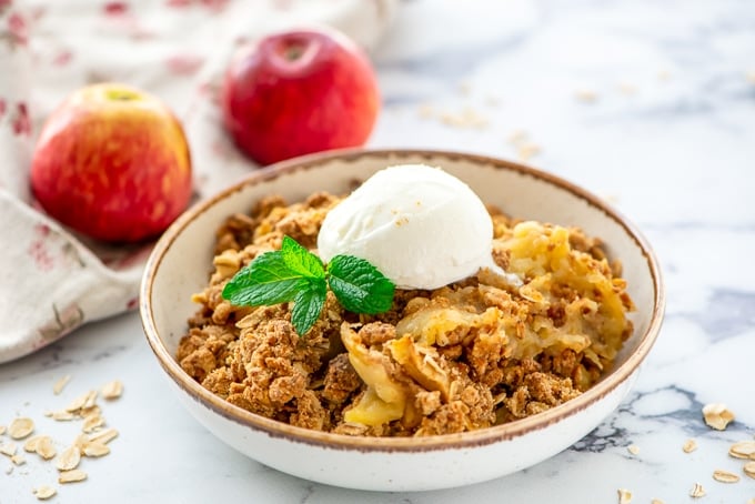 Old Fashioed Apple Crisp dished out in bowl with ice cream.