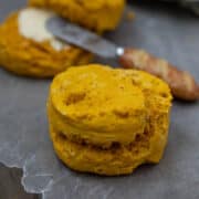 Sweet Potato Biscuit on wax paper with buttered biscuit in background