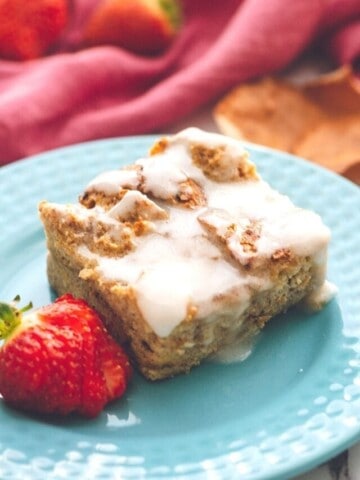 French toast casserole on blue plate with strawberries