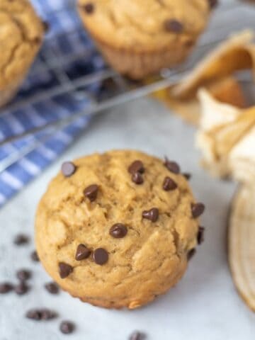 Healthy Banana Muffin next to cooling rack with chocolate chips
