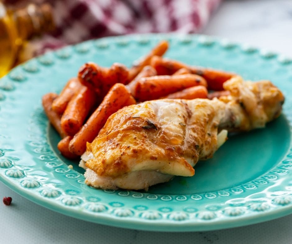 Rotisserie Chicken on blue plate with roasted carrots