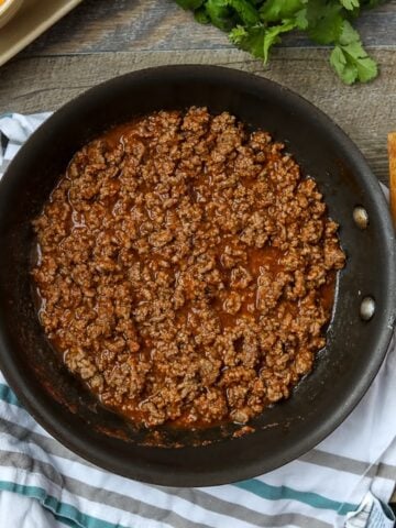 Taco Meat in skillet with wooden spoon