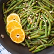 Saute Pan with freshly sauteed green beans sprinkled with chopped pecans