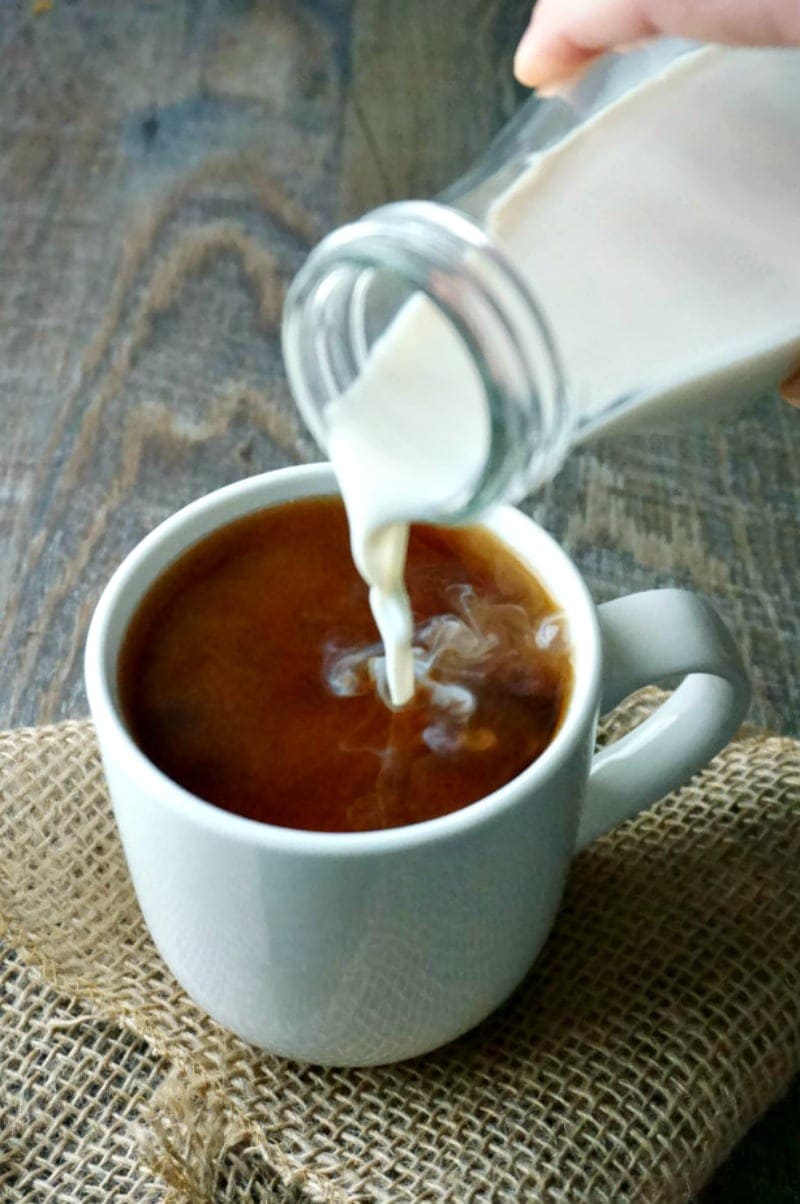 Coconut Vanilla Coffee Creamer being poured into coffee cup
