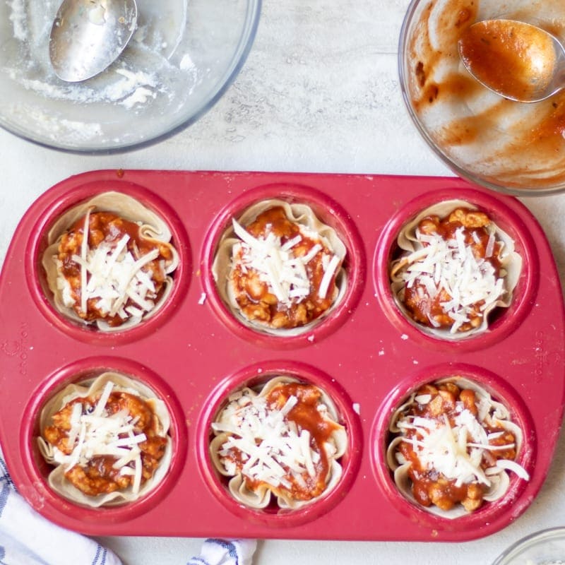 Lasagna Cups ready for oven in red muffin cup liner