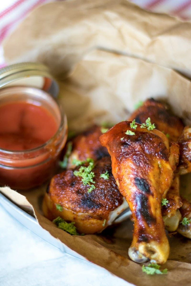 Chicken drumsticks in basket that have been made in crockpot with homemade bbq sauce