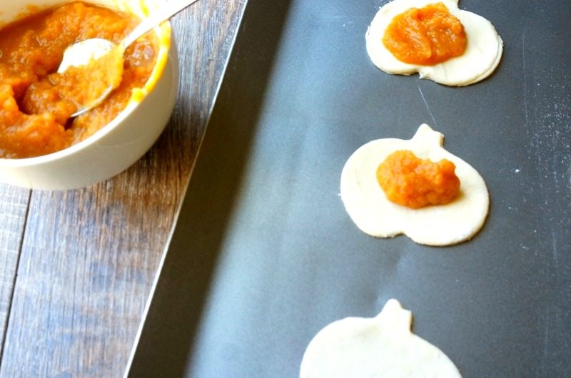 Pumpkin Filling on top of pie crust shaped like pumpkins