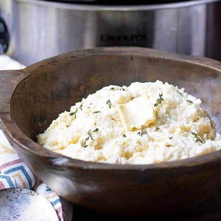 Bowl of Crockpot Mashed Potatoes next to slow cooker