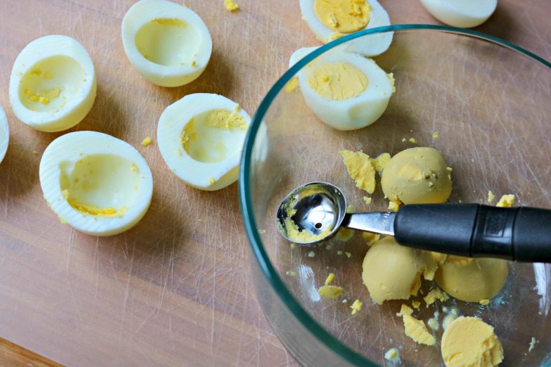 Hard Boiled Eggs Sliced Open with yolks in mixing bowl.