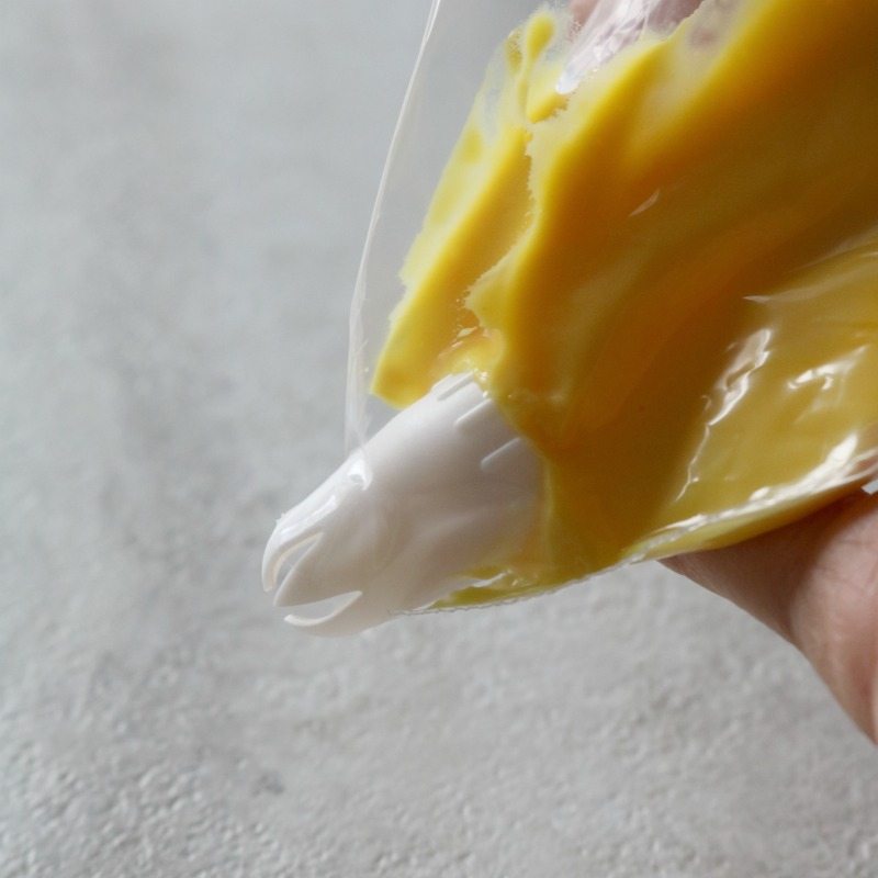 Yellow Egg Filling in piping bag with star tip.