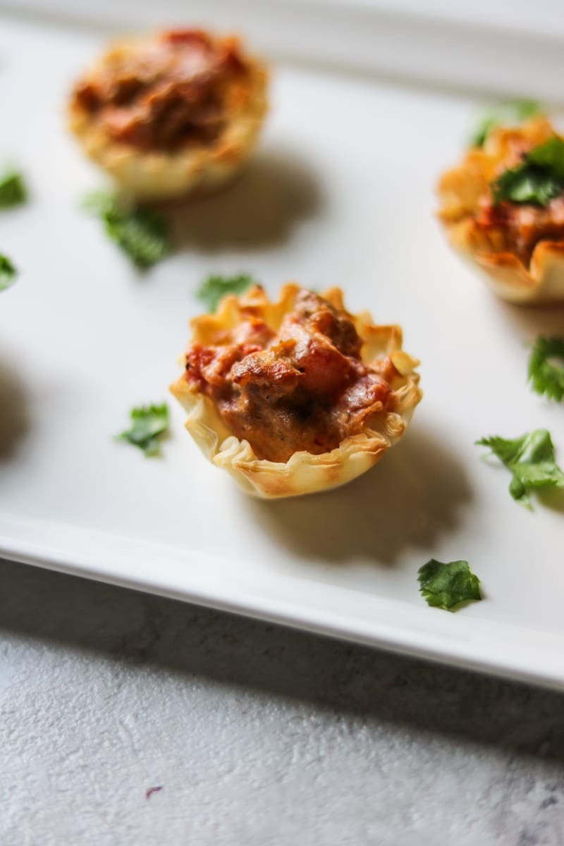 Spicy Turkey Sausage Rotel Dip filled in phyllo cups and sprinked with cilantro