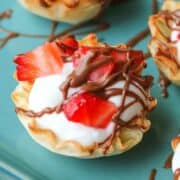 Greek Yogurt in phyllo cup with strawberries and chocolate drizzle