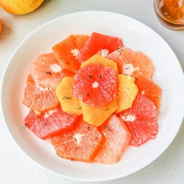 Bowl of winter citrus fruit with thyme syrup