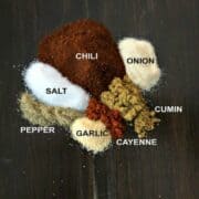 Chili seasonings labled on wooden board