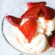 Bowl of vanilla ice cream topped with balsamic soaked strawberries