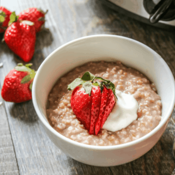 Bowl of oatmeal topped with strawberries and yogurt