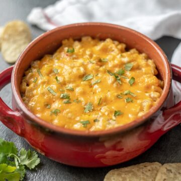 Red skillet of creamy Mexican corn dip