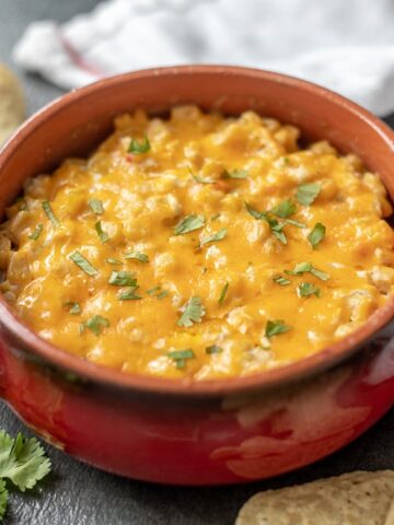 Red skillet of creamy Mexican corn dip