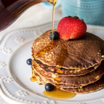 Healthy Pancakes with syrup being poured on them. Gluten free oatmeal blender pancakes