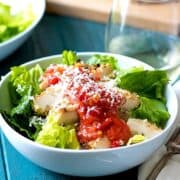Bowl of Chicken Parmesan Salad with fresh tomato sauce