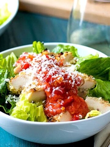 Bowl of Chicken Parmesan Salad with fresh tomato sauce