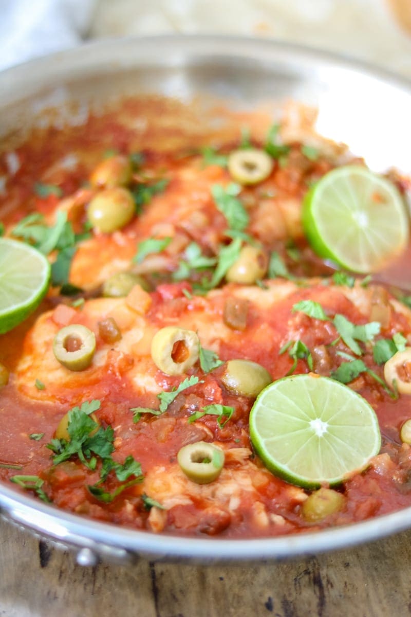 Skillet with cooked tilapia in a veracruz sauce