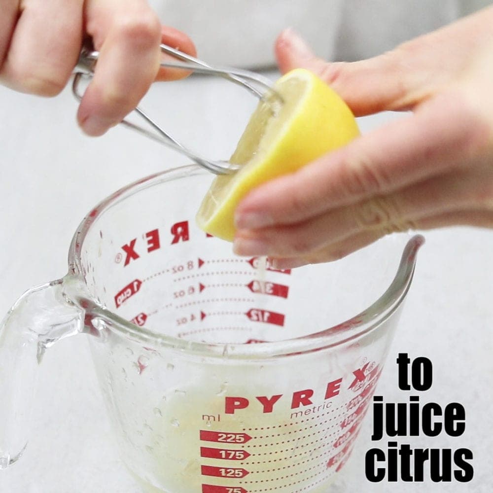 Mixer Attachement juicing a lemon over glass with title text that reads to juice citurs