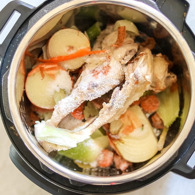 chicken bones and vegetables in inner pot