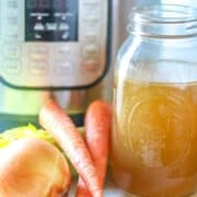 Bone Broth sitting next to Instant Pot and Carrots and Onions