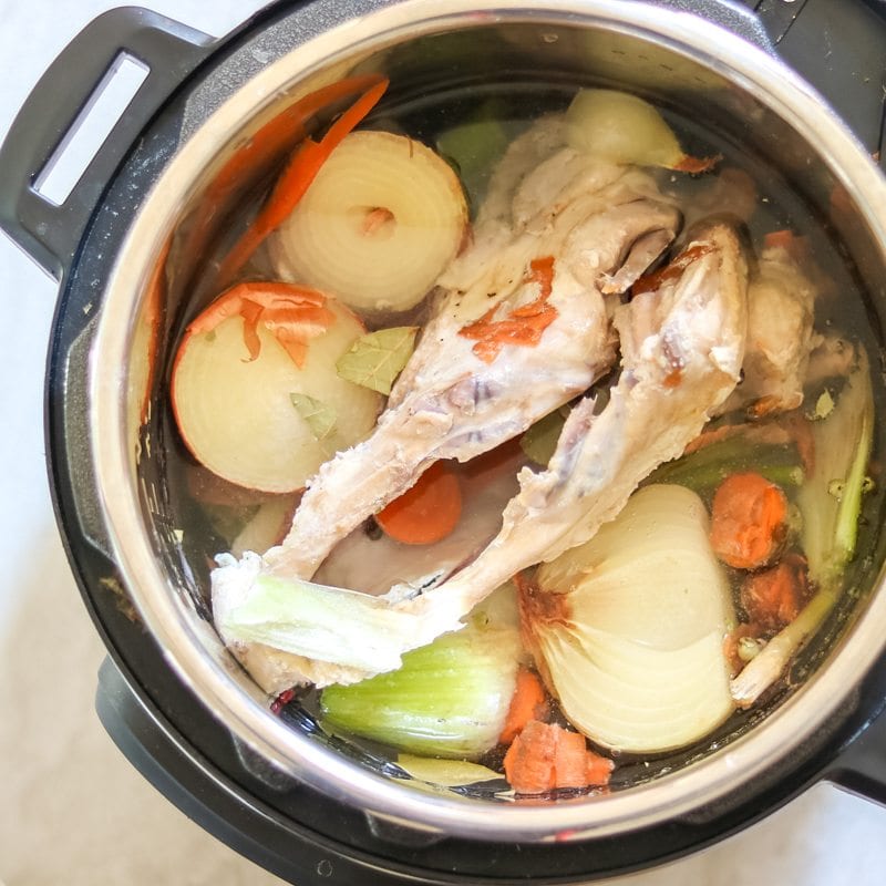 Water and seasoning added to chicken bones and vegetable scraps