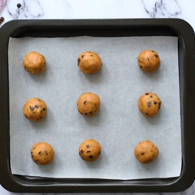 Neiman Marcus Cookie Dough Balls spaced on baking sheet. 