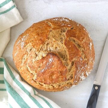 Dutch Oven Bread next to serrated knife