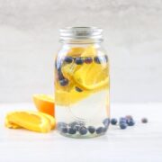 Ball jar filled with water that has orange slices and blueberries in it for Blueberry orange water