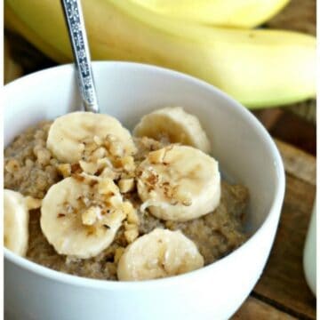 bowl of quinoa porridge topped with bananas and nuts